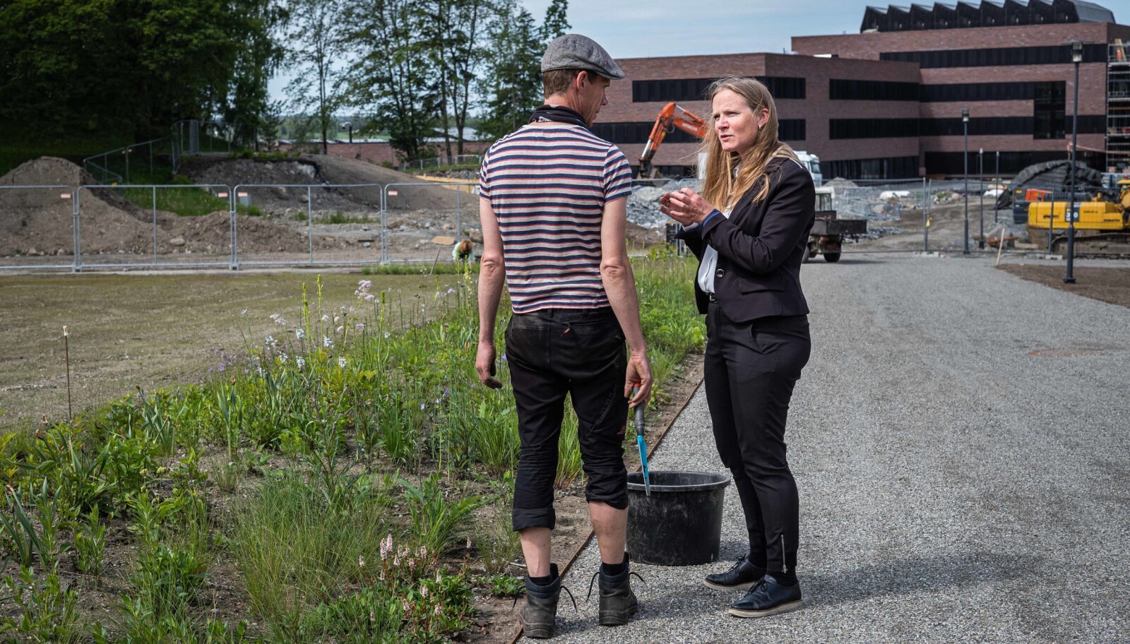 Mari Sundli Tveit prater med en gartner. Her skal det bli ny, fin hage. — Parkene er det jeg liker best med NMBU, sier Mari Sundli Tveit. Foto: Siri Øverland Eriksen. Mari Sundli Tveit prater med en gartner. Her skal det bli ny, fin hage. — Parkene er det jeg liker best med NMBU, sier Mari Sundli Tveit. Foto: Siri Øverland Eriksen.