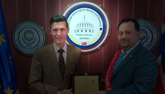 Shaaban's office with the logo of Bay Ridge University in the background. Shaaban's office with the logo of Bay Ridge University in the background.