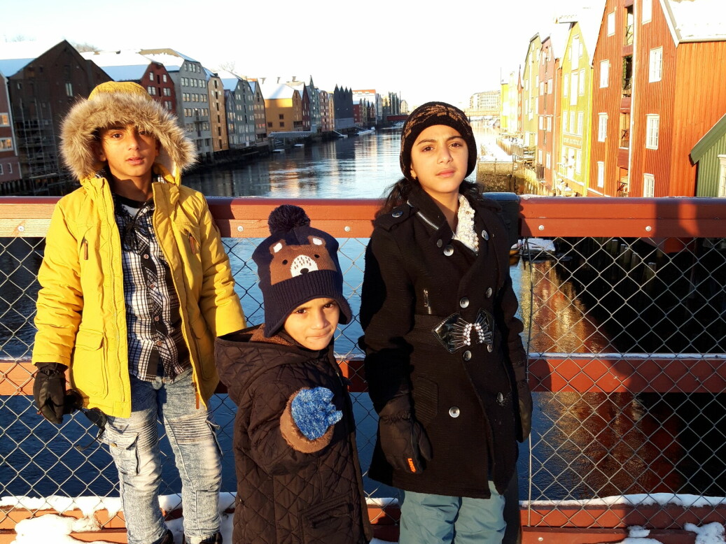 Ali, Ameer and Fatima standing at the Old Town Bridge in Trondheim.