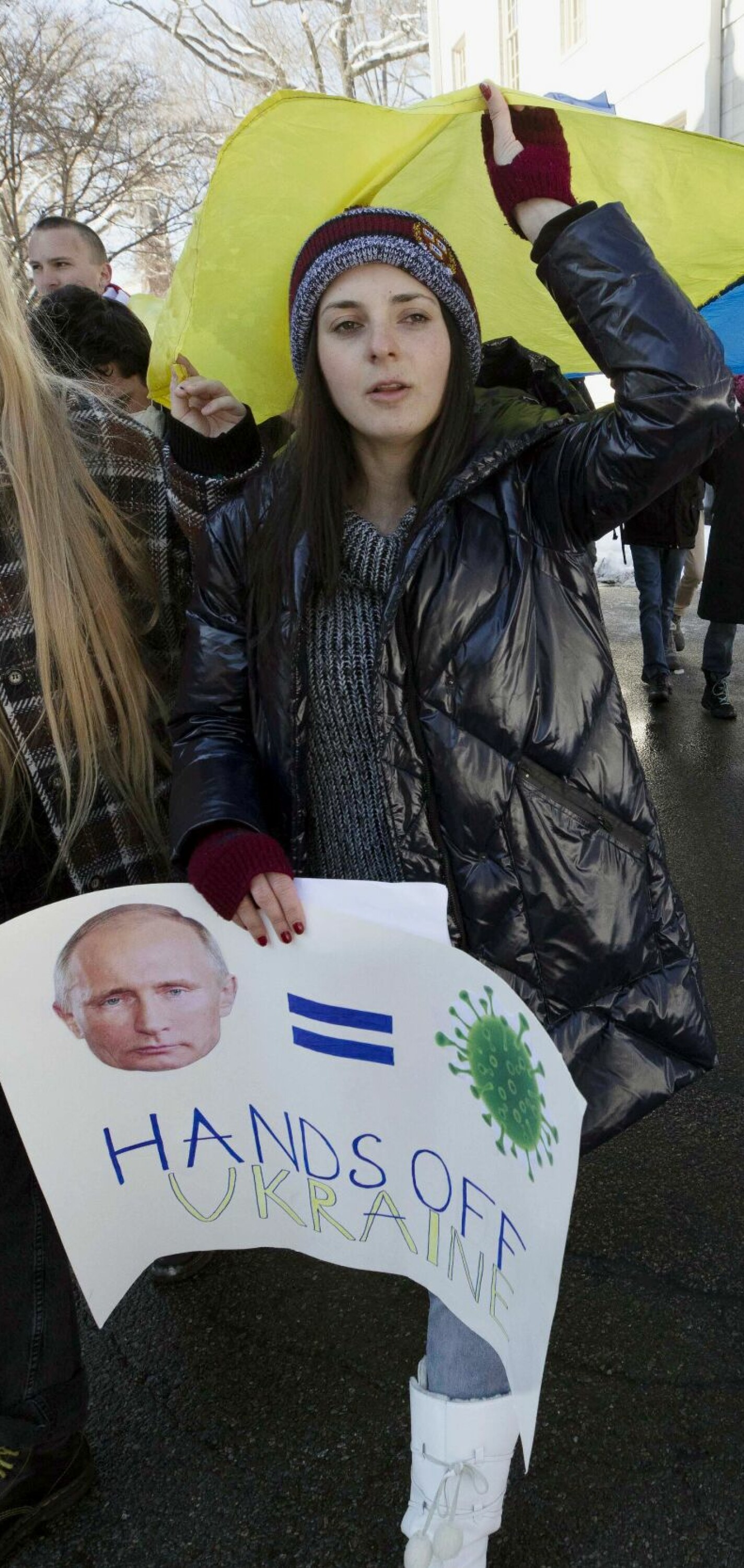 FILE - Harvard University student Nika Rudenko, second from right, marches on campus in support of Ukraine, Saturday, Feb. 26, 2022, in Cambridge, Mass. (AP Photo/Michael Dwyer, File)