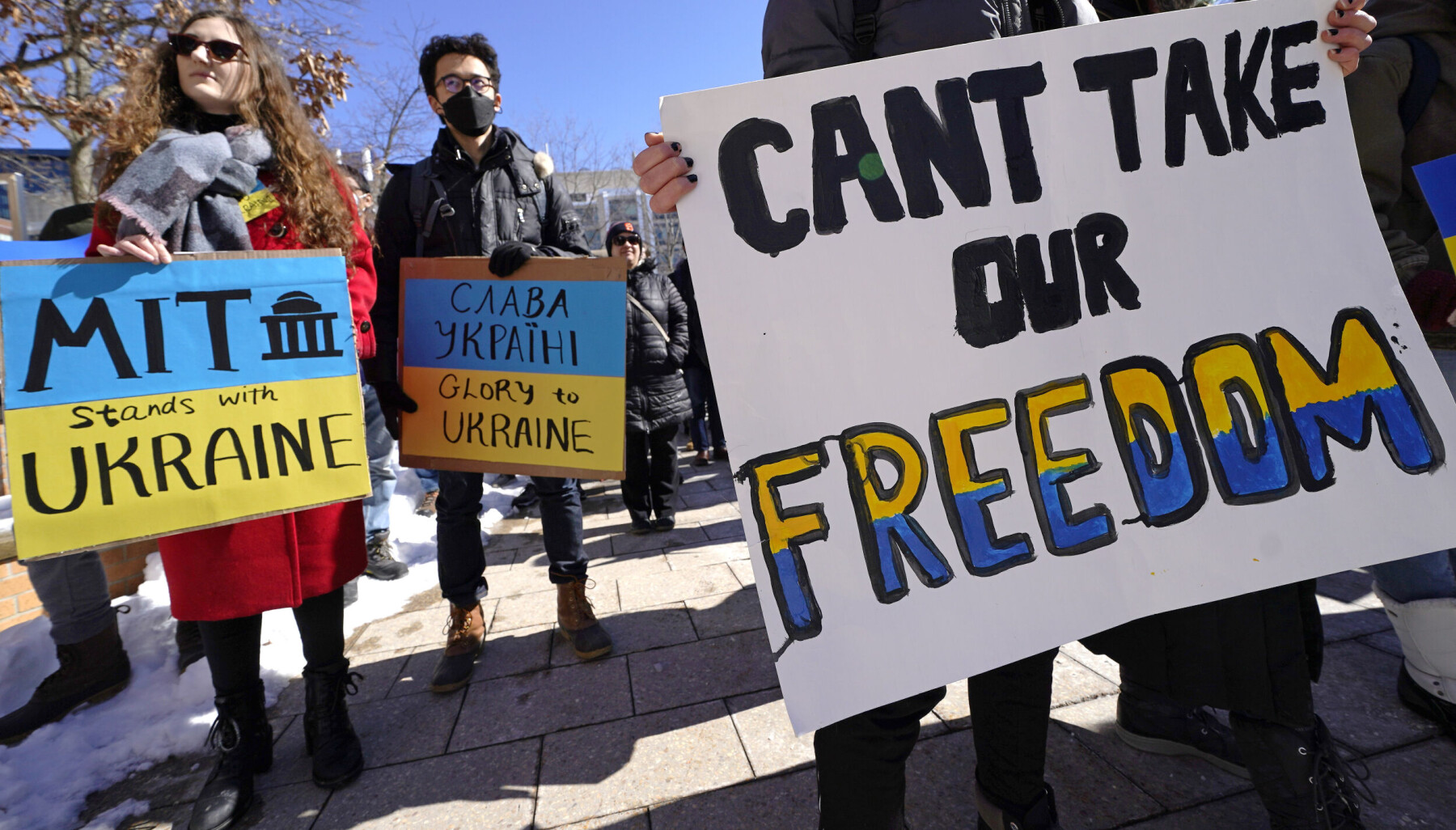 Demonstrators clutch placards during a rally in support of Ukraine, during a protest on Monday, Feb. 28, 2022, at the Massachusetts Institute of Technology in Cambridge, Mass. MIT has severed ties with a research university it helped establish in Russia, citing the country's "unacceptable" invasion of Ukraine. The Cambridge university said it notified the Skolkovo Institute of Science and Technology in Moscow on Friday, Feb. 25, 2022, that it was exercising its right to terminate the MIT Skoltech Program. (AP Photo/Charles Krupa) Demonstrators clutch placards during a rally in support of Ukraine, during a protest on Monday, Feb. 28, 2022, at the Massachusetts Institute of Technology in Cambridge, Mass. MIT has severed ties with a research university it helped establish in Russia, citing the country's "unacceptable" invasion of Ukraine. The Cambridge university said it notified the Skolkovo Institute of Science and Technology in Moscow on Friday, Feb. 25, 2022, that it was exercising its right to terminate the MIT Skoltech Program. (AP Photo/Charles Krupa)