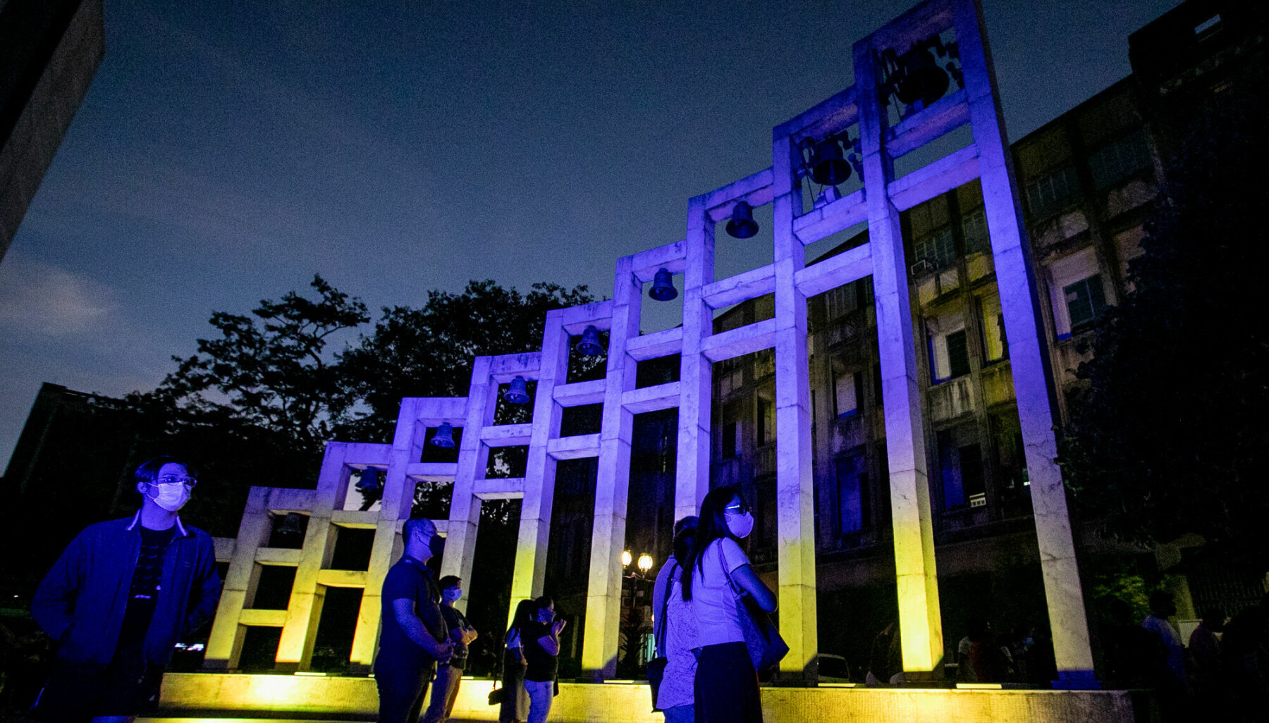 March 2, 2022, Manila, Philippines: People walk past the Santisimo Rosario Parish where the flag of Ukraine is projected as a show of support for the country at the University of Santo Tomas in Manila, Philippines. March 2, 2022. Other countries in Southeast Asia like Singapore and Indonesia have condemned Russiaâ€™s invasion of Ukraine, while the Philippines has called for a peaceful resolution on the conflict and have expressed concerns over the safety of Filipinos fleeing from the war-stricken eastern European country.