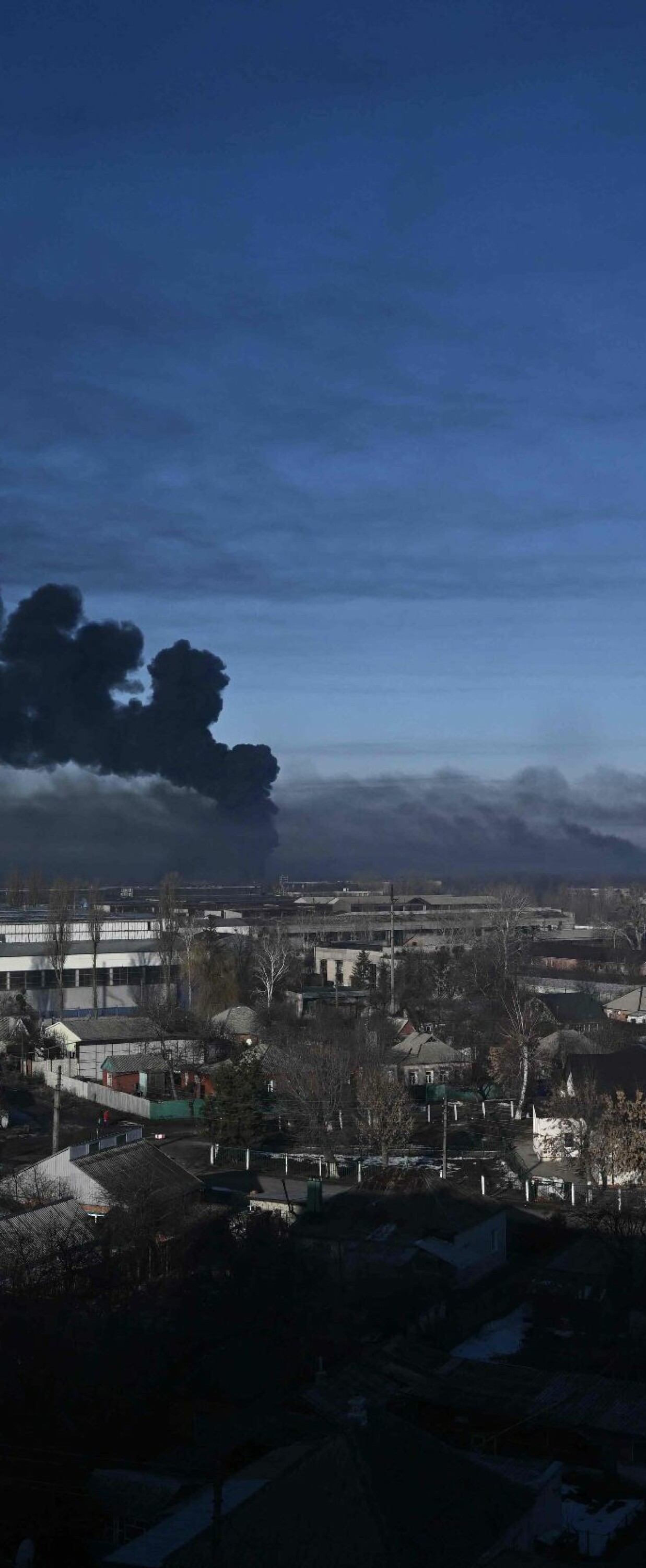 TOPSHOT - Black smoke rises from a military airport in Chuguyev near Kharkiv  on February 24, 2022. - Russian President Vladimir Putin announced a military operation in Ukraine today with explosions heard soon after across the country and its foreign minister warning a "full-scale invasion" was underway. (Photo by Aris Messinis / AFP)