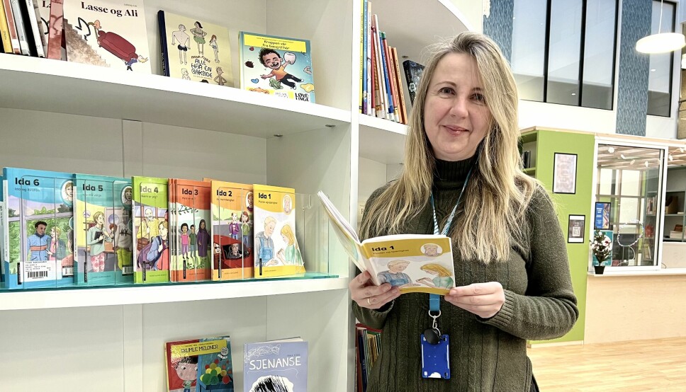 Irina Reitan på biblioteket til Trovo. Når elevene skal lære seg norsk er barnebøker en god start.